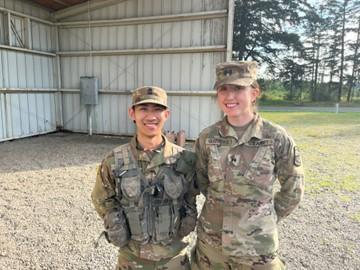 two cadets in army greens outside
