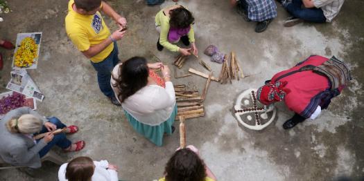 People from specific culture doing art on the ground