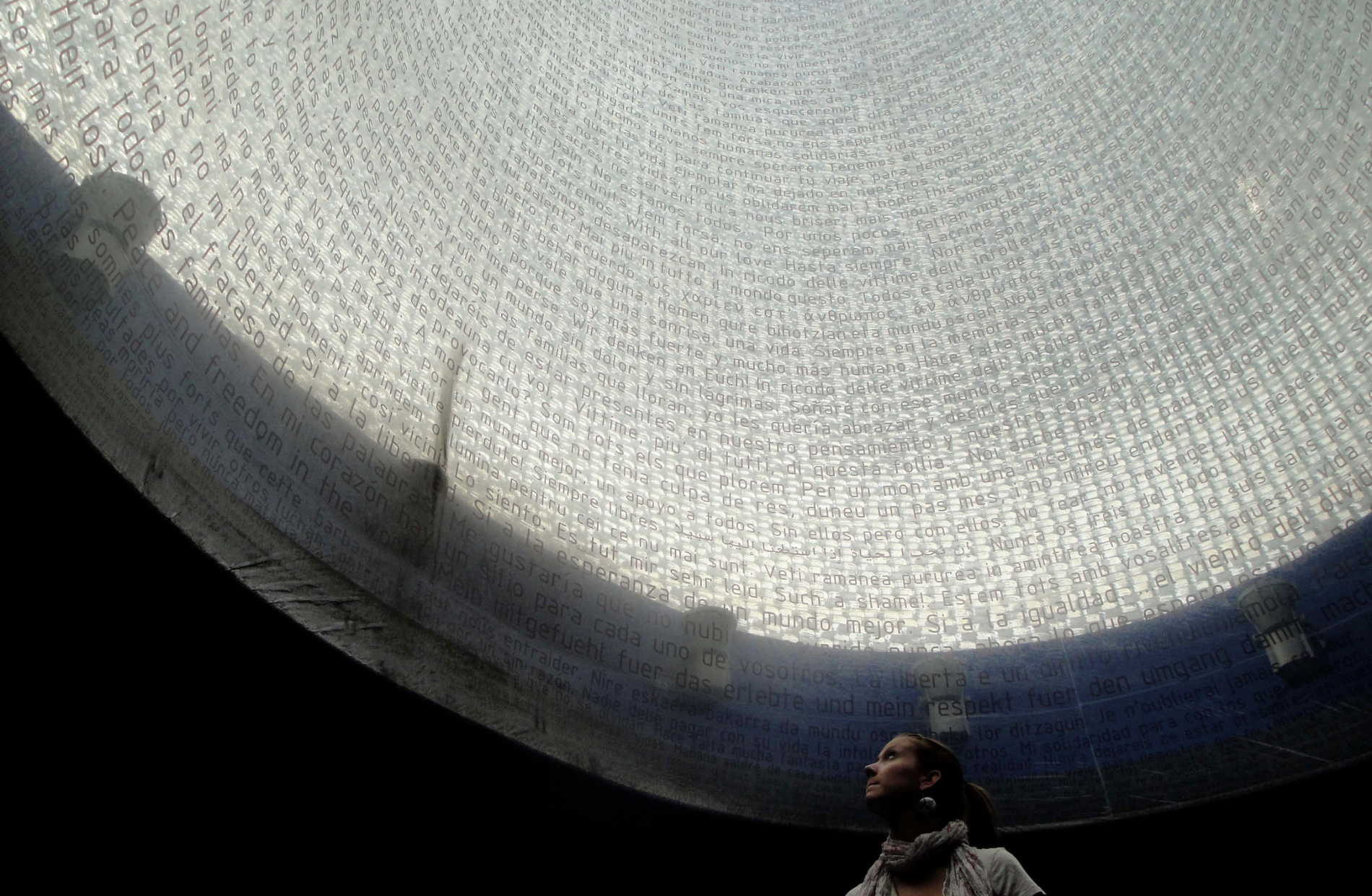 woman looking up at a translucent dome lined with words