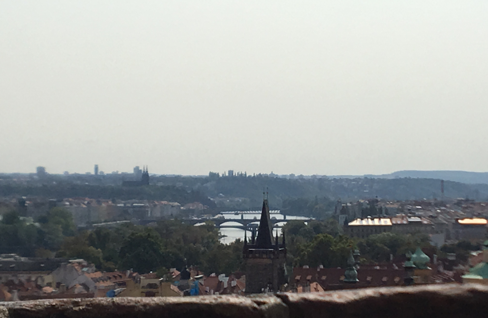 view from a mountain top looking down at the sprawling city of Prague