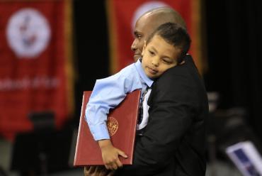 Father holding child at Commencement