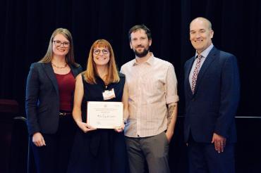 Four people with one holding a certificate that shows The Sip and Snack as second place winner in the Harriet Stephenson Business Plan Competition