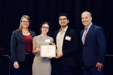 Four people with one holding a certificate that says Groveyard won fourth place in the Harriet Stephenson Business Plan Competition