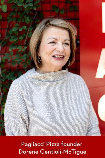 A brown-haired woman smiling in the distance