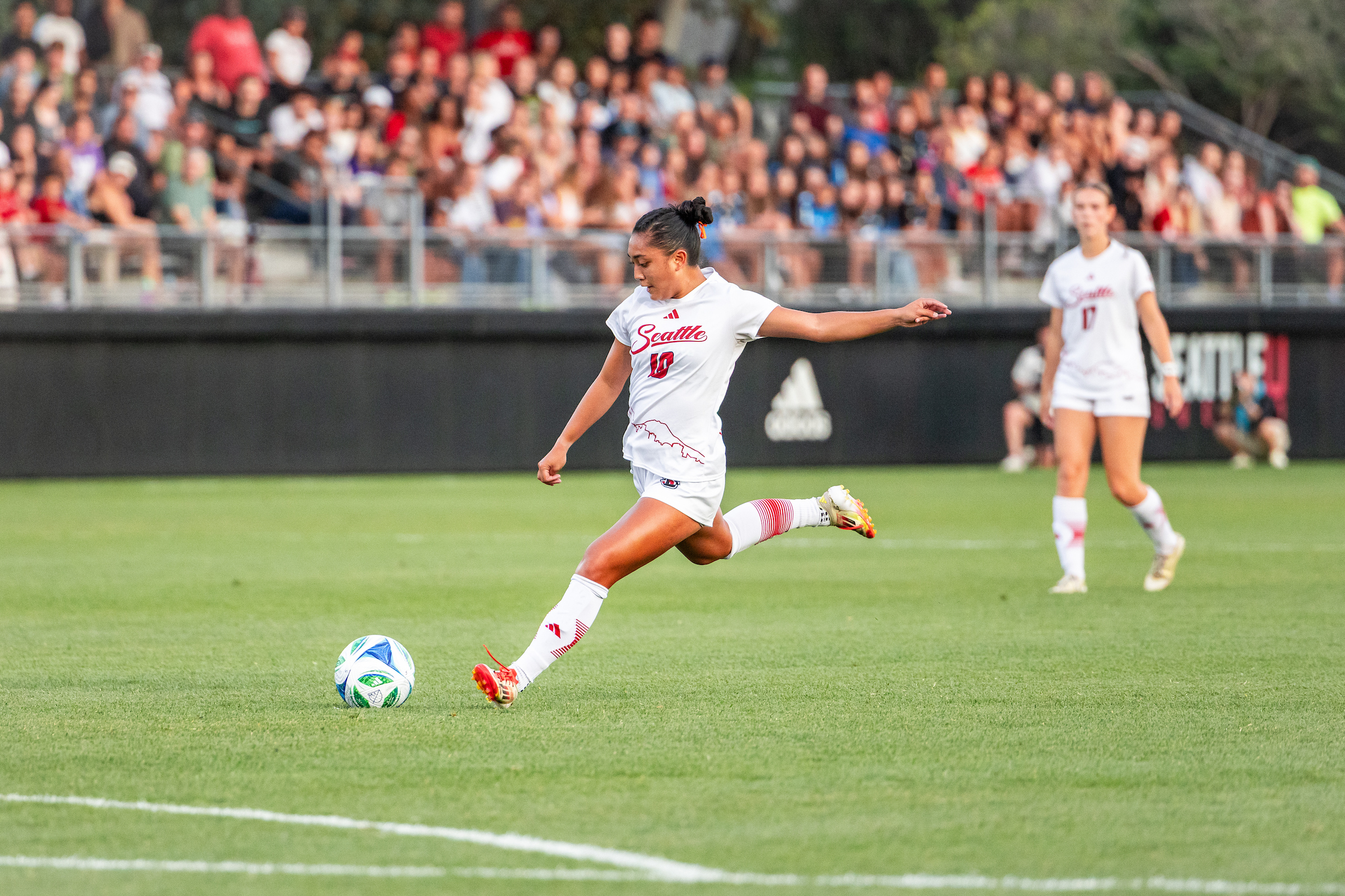 Female soccer player hitting a soccer ball