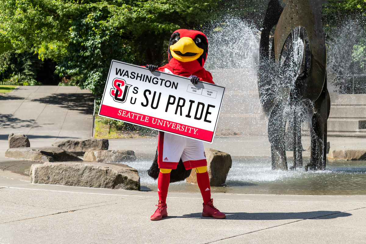 Rudy holding an SU Pride License Plate