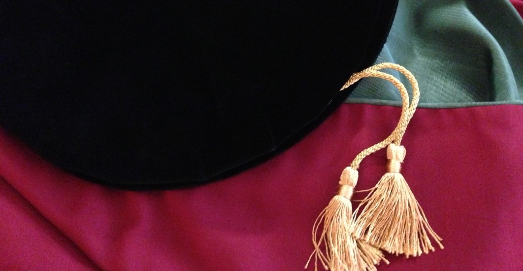 Doctoral robes and cap with tassels in the shape of a question mark