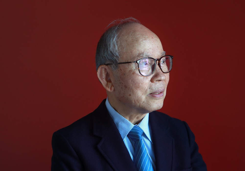 Peter L. Lee against red background