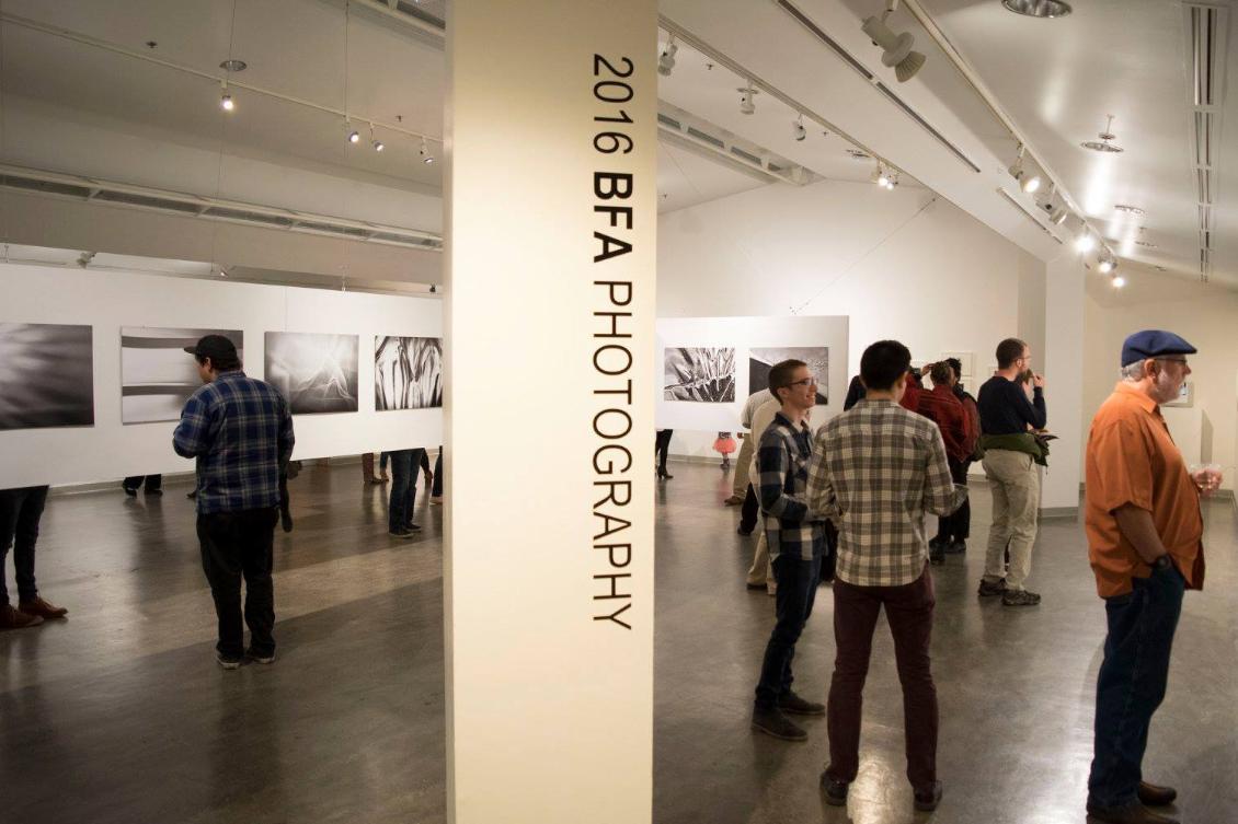 Photo of exhibition in gallery with visitors