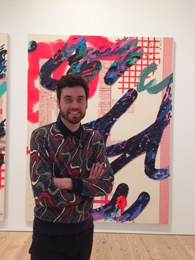 Photo of David Strand in front of artwork