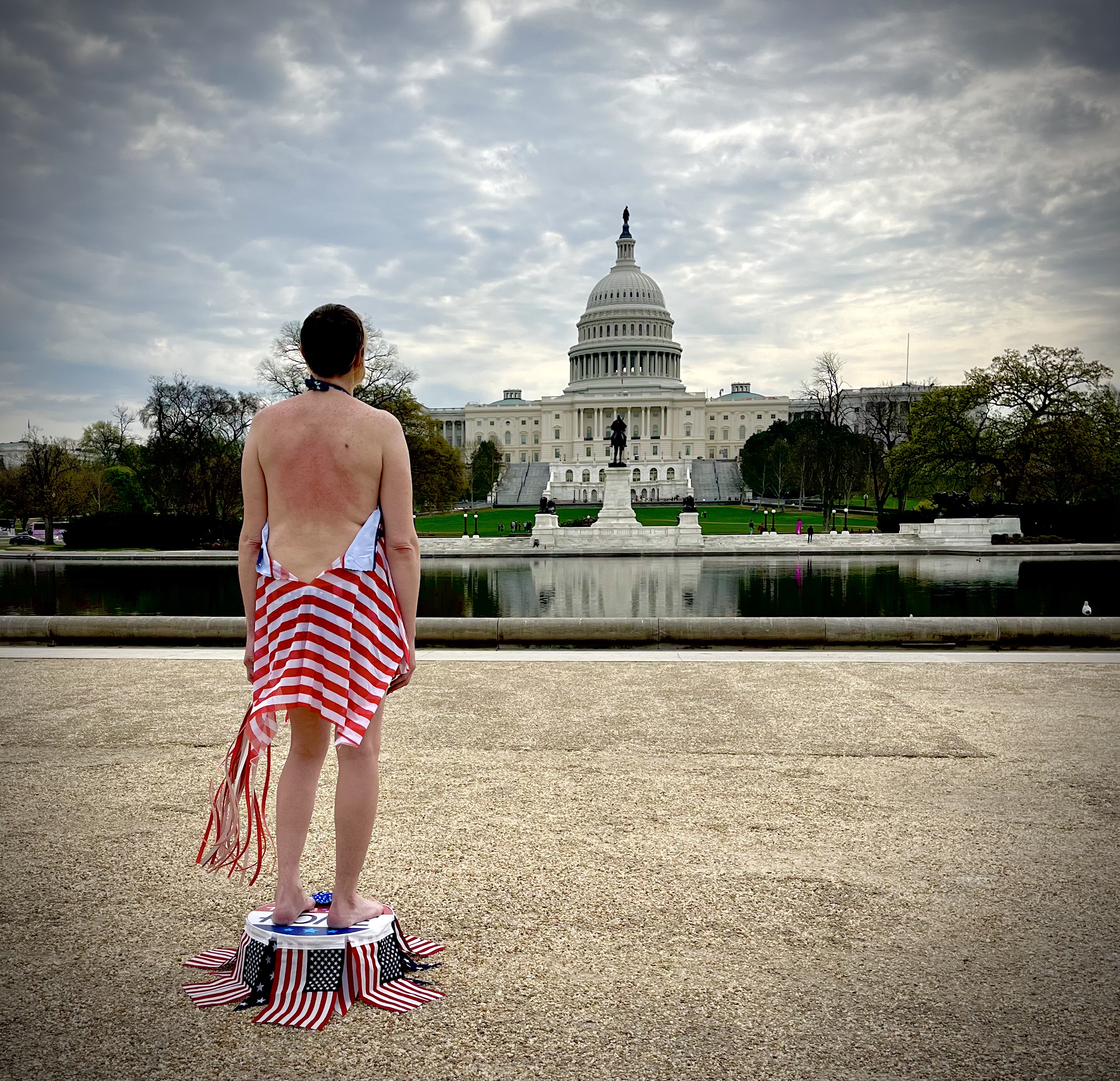 a person standing in front of the us capitol with a bare back
