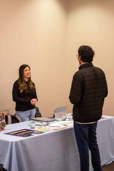 two students talking at a conference