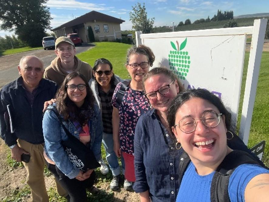 seven people smiling outdoors