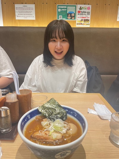 Kana Komoto at a table with food