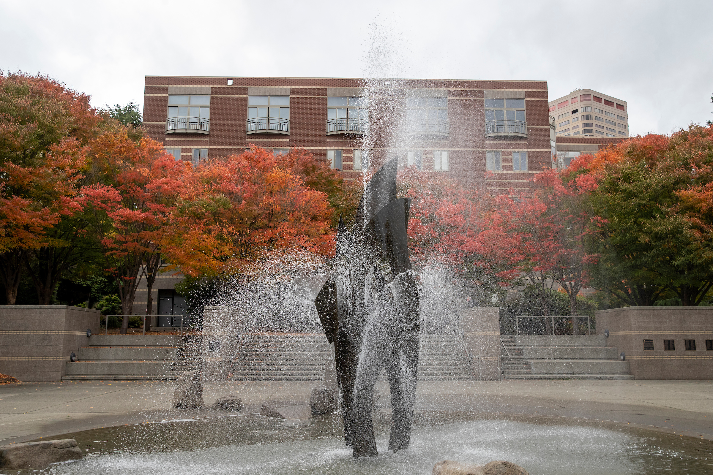 Fountain with autumn trees in the background