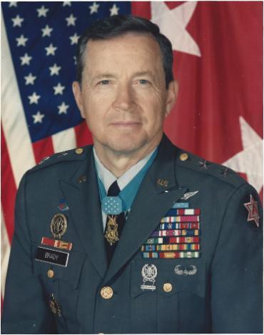 Major General Patrick in dress uniform in front of American flag